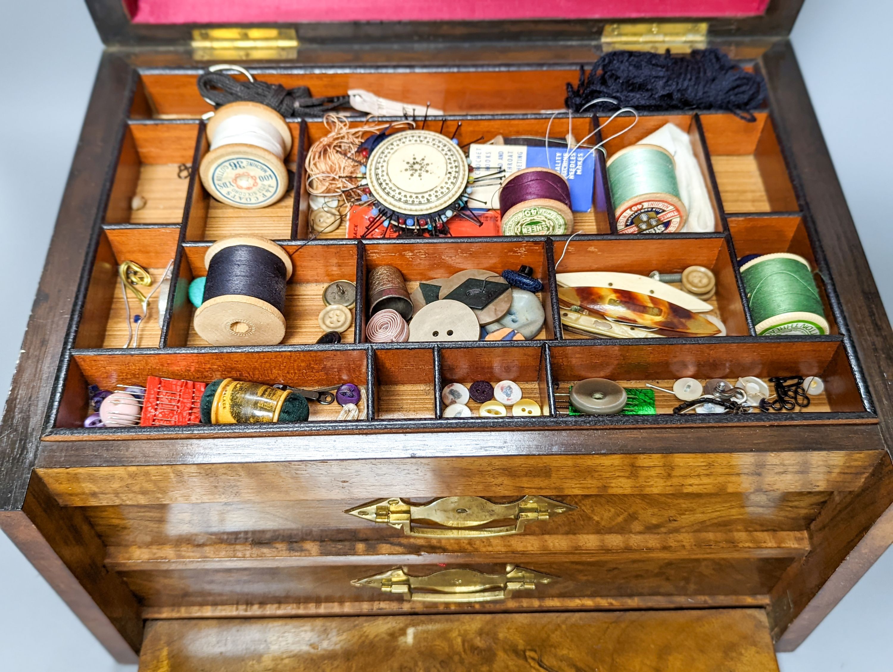 A Victorian walnut sewing casket, 34cm, containing sewing related accessories